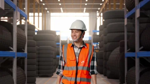 Front View of Asian Male Engineer Waving Hand Saying Bye While Walking at Tire Stock Footage 341784314