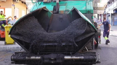 Front view of asphalt paving machine in action charged with warm mix asphalt Stock Footage 253230838