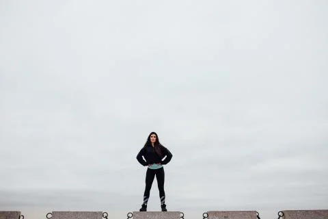 Front view of athlete after exercising standing on stone proudly and contentedly Stock Photos