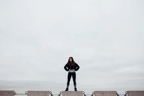 Front view of athlete after exercising standing on stone proudly and contentedly Stock Photos
