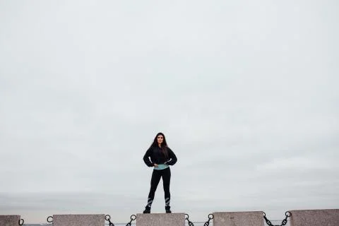 Front view of athlete after exercising standing on stone proudly and contentedly Stock Photos