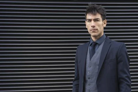 Front view of an attractive executive man wearing a suit while looking at c.. Stock Photos