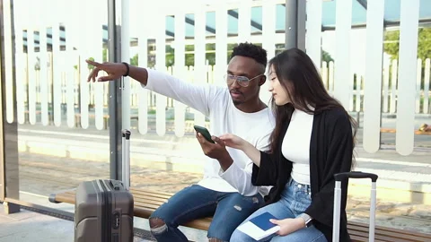 Front view of attractive positive satisfied mixed race friends which sitting on Stock Footage 138743451
