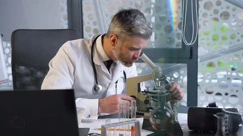 Front view of attractive respected gray-haired male doctor which working in the Stock Footage 122632572
