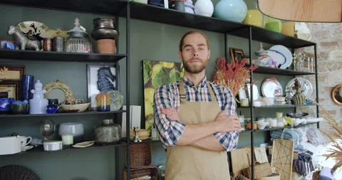 Front view of attractive smiling confident bearded man in apron which posing on Stock Footage 143969122