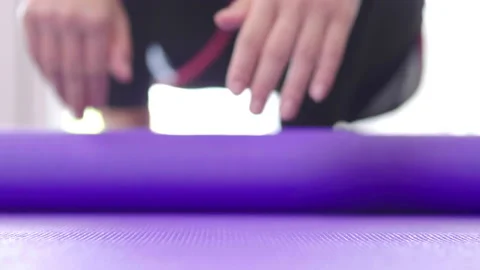 Front view of B roll shot of woman roll out yoga mat for preparation Stock Footage 168224432