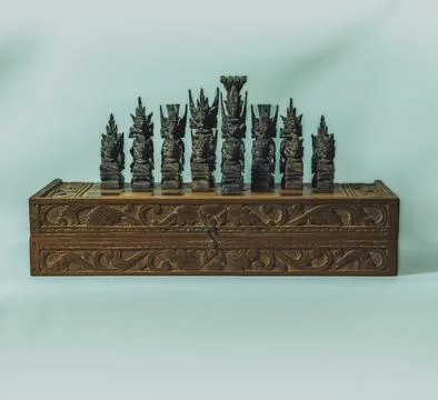 Front view of  Balinese Chess Set on top of a Carved Wooden Box 스톡 사진
