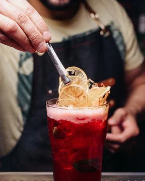 Front view bartender preparing a red drink Stock Photos