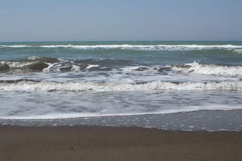 Front view of beach waves at the sea shore Stock Photos
