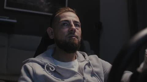Front view of A bearded man using a driving simulator Vídeo Stock 258389188