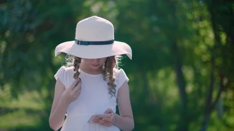 Front view of beautiful girl using smartphone in park Video stock 130399476