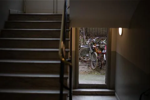 Front view on bicycles that are parked near the entrance of the house Stock Photos