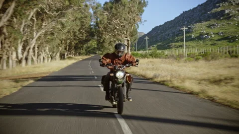 Front view of a Biker riding on a stunning road Stock Footage 279269409