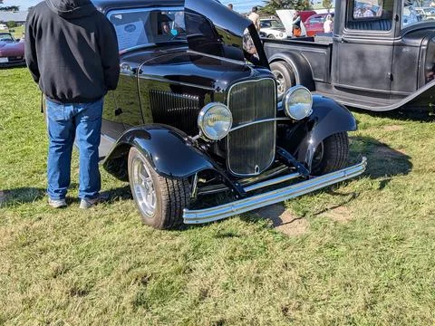 Front view of black 1933 Ford Tudor Sedan with partially open hood Stock Photos