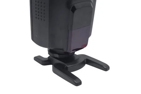 Front view of a black camera flash speedlight with an optical sensor mounte.. 스톡 사진