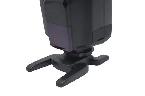 Front view of a black camera flash speedlight with an optical sensor mounte.. Stock-Fotos
