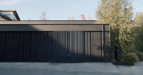 Front view on black car leave modern garage with automatic open gate Video stock 251542093