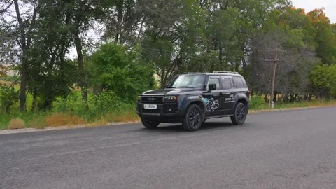Front view of a black Land Cruiser 250 on a road Stock Footage 310835823