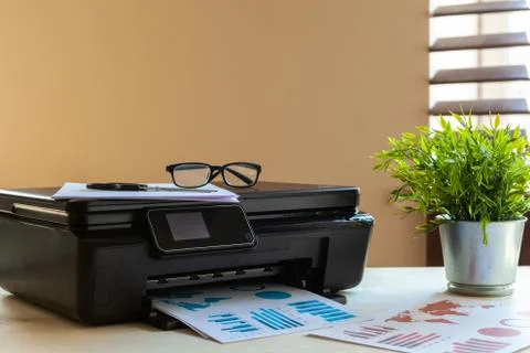 Front view of a black printer machine on a table Stock Photos