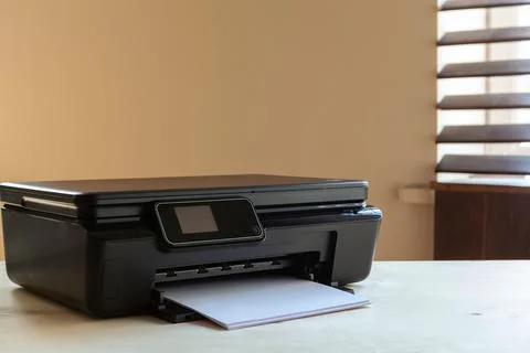 Front view of a black printer machine on a table Stock Photos