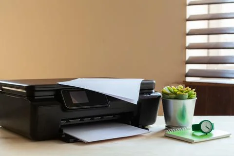 Front view of a black printer machine on a table Stock Photos