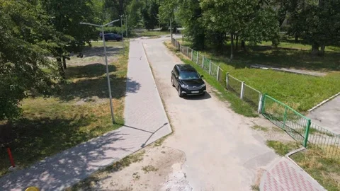 Front view of a black off-road car on a city street from a height. Mixed media Stock Footage 159695862