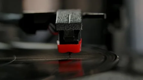 Front view black vinyl record spins on an old school turntable. Close up of a Stock Footage 143944779