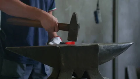 Front View of Blacksmith Hammering Hot Metal on Anvil – Traditional Forging Stock Footage 313849868