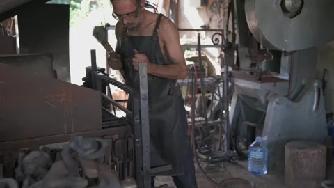 Front view of a blacksmith in his workshop marking a decorative grille with.. Stock Footage 253253055
