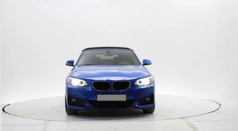 A front view of a blue convertible BMW Stock Photos