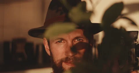 Front view of blurry plants with man in background taking recording Stock Footage 203577846