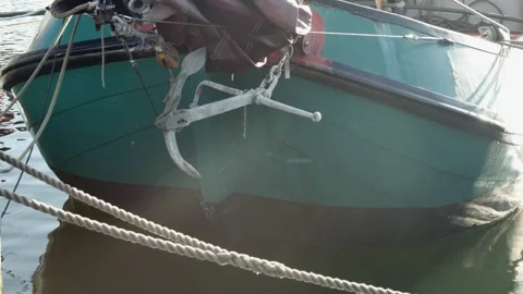 Front view of the bow of a sailing green boat with an anchor Vídeos de archivo 258551609