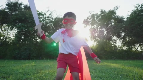 Front view of boy playing sword in the park, holding a sword in his hand Stock Footage 173357605