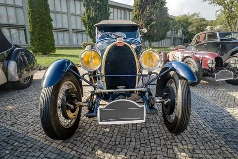 Front view of Bugatti Type 40 on cobblestone drive on sunny day Stock Photos