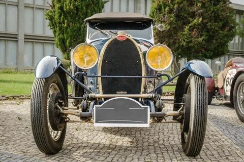Front view of Bugatti Type 40 on cobblestone drive on sunny day Stock Photos