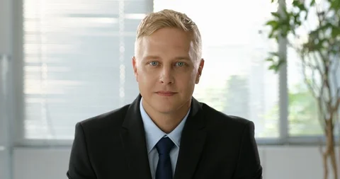 Front view of a Businessman sitting down and making a video call Stock Footage 100954016