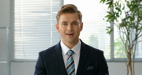 Front view of a Businessman sitting down and making a video call Stock Footage 100954367