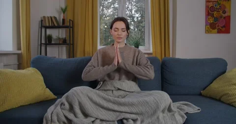 Front view of calm lady meditating at home with joined palms in Namaste mudra Stock Footage 143442760