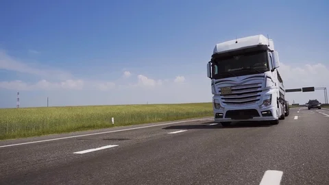 Front-view camera follows a white truck driving on a highway. Video stock 126093294