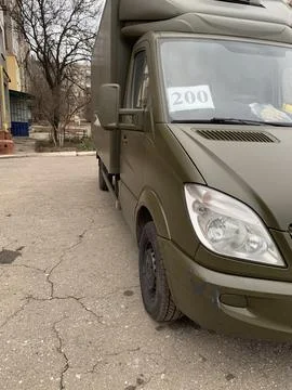 Front view of a camouflage van. Stock Photos