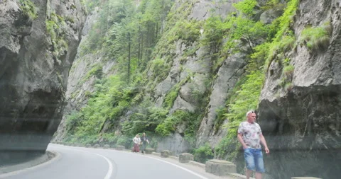 Front view car drive between steep rock walls of Bicaz Gorges Video stock 318253594