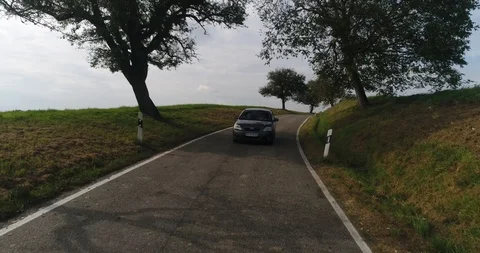 Front view at the car driving along the country road surrounded by trees. Beauty Stock Footage 87473773