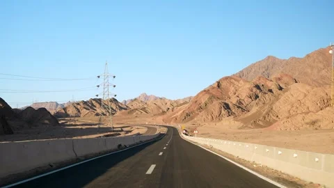 Front view of car driving on the empty asphalt highway in the desert with road Stock Footage 251885589