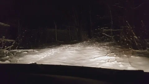 Front view of car making J-turn at night, police 180 degree turn on snow Stock Footage 84043077