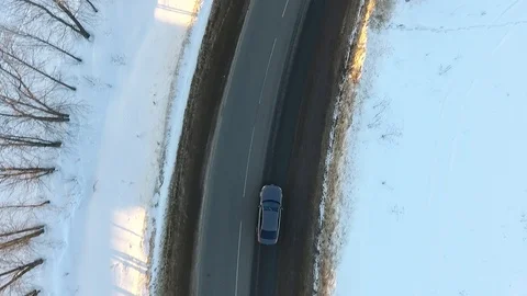 Front view from car mounted camera when vehicle driving winter snowy forest road Stock Footage 104576585