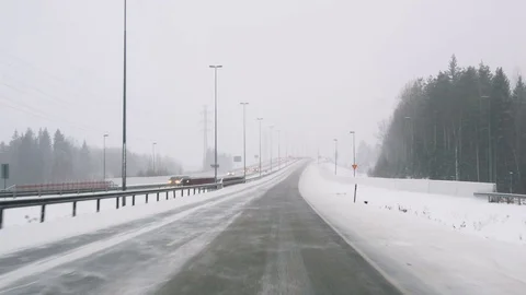 Front view from the car on snowy ice road through the forest Stockbeeldmateriaal 71832808