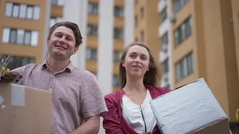Front view Caucasian couple walking with packed parcels in slow motion outdoors Video stock 167554700
