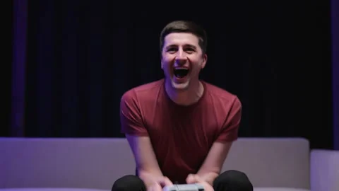 Front view of caucasian guy playing video game and using joystick . Handsome Stock Footage 194551157