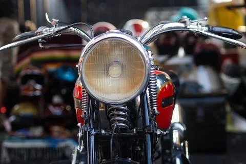 Front view centered close up of vintage motorcycle headlight and chrome han.. Stock Photos