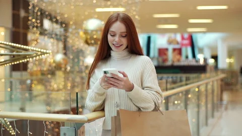 Front view of charming smiling young woman typing online message in social media Stock Footage 166016758
